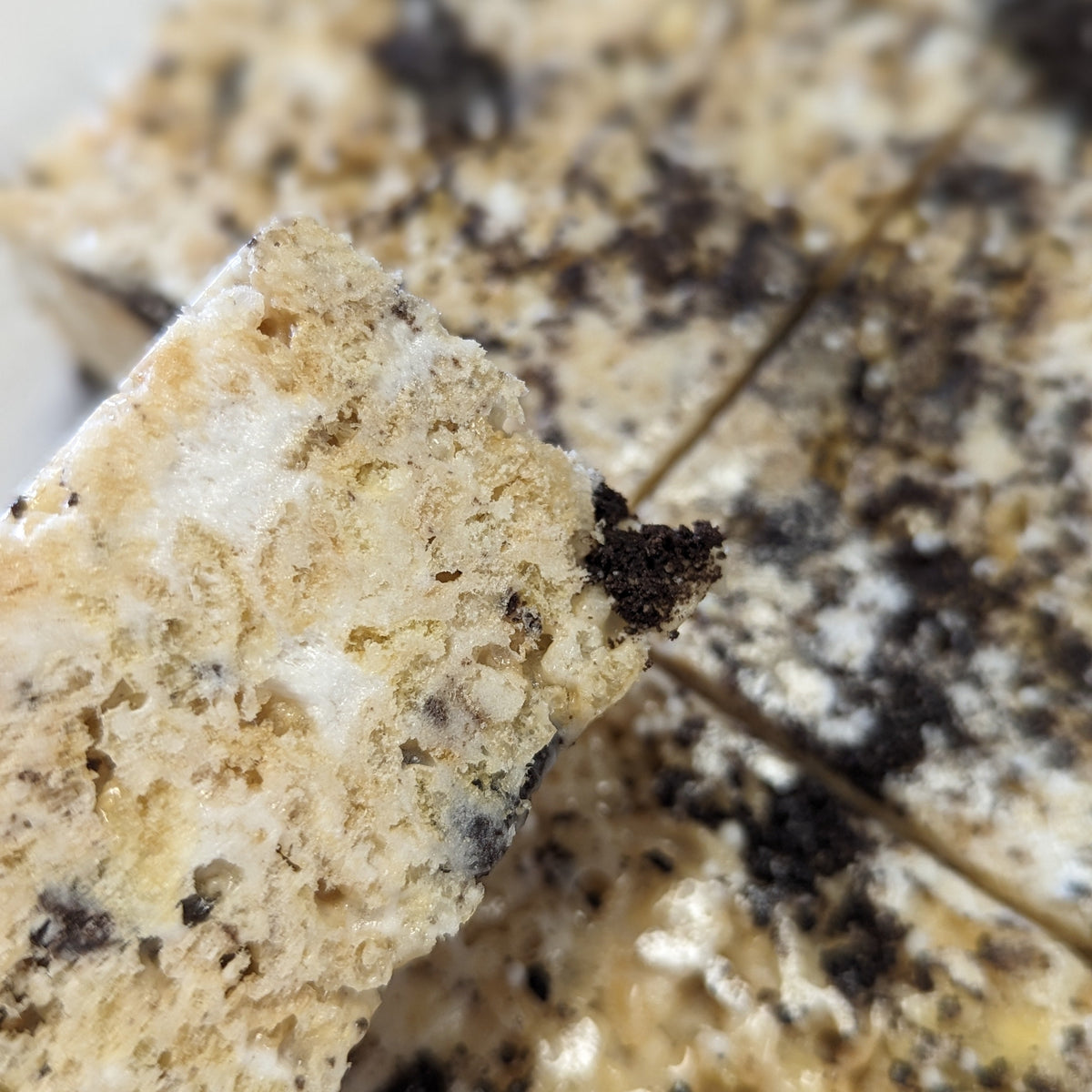 close up of cookies and cream rice cereal treat with bits of marshmallow